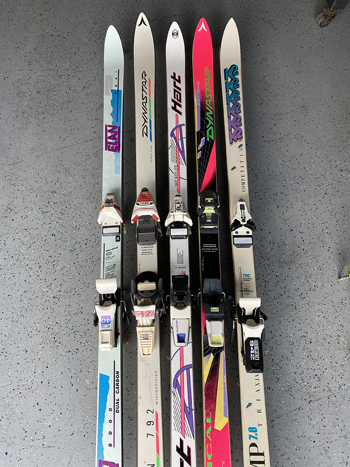 collection of skis with 80's fashion colors on display as sample for colors and brands for custom ski chair
