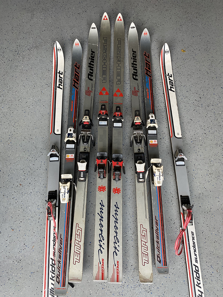 collection of silver skis on display as sample for colors and brands for custom ski chair